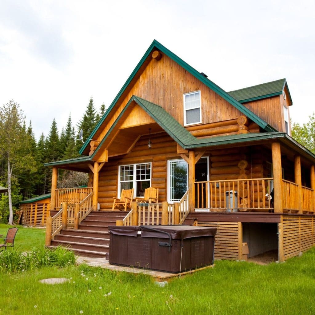 Huge log cabin home with a big porch.