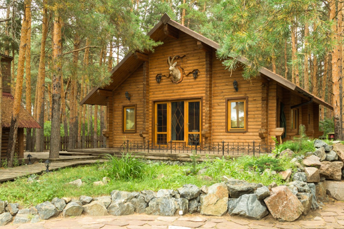 Finished log cabin house in the nature.