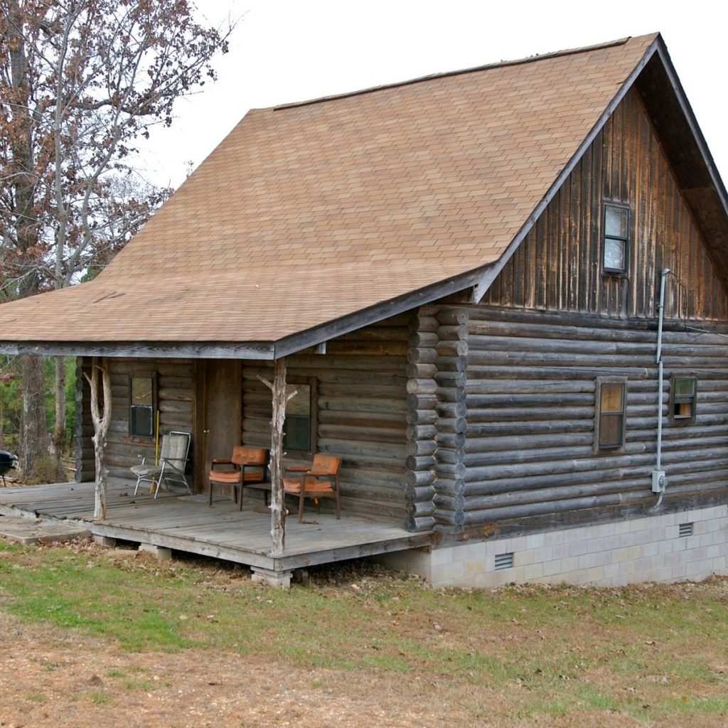 Simple log cabin with a porch.