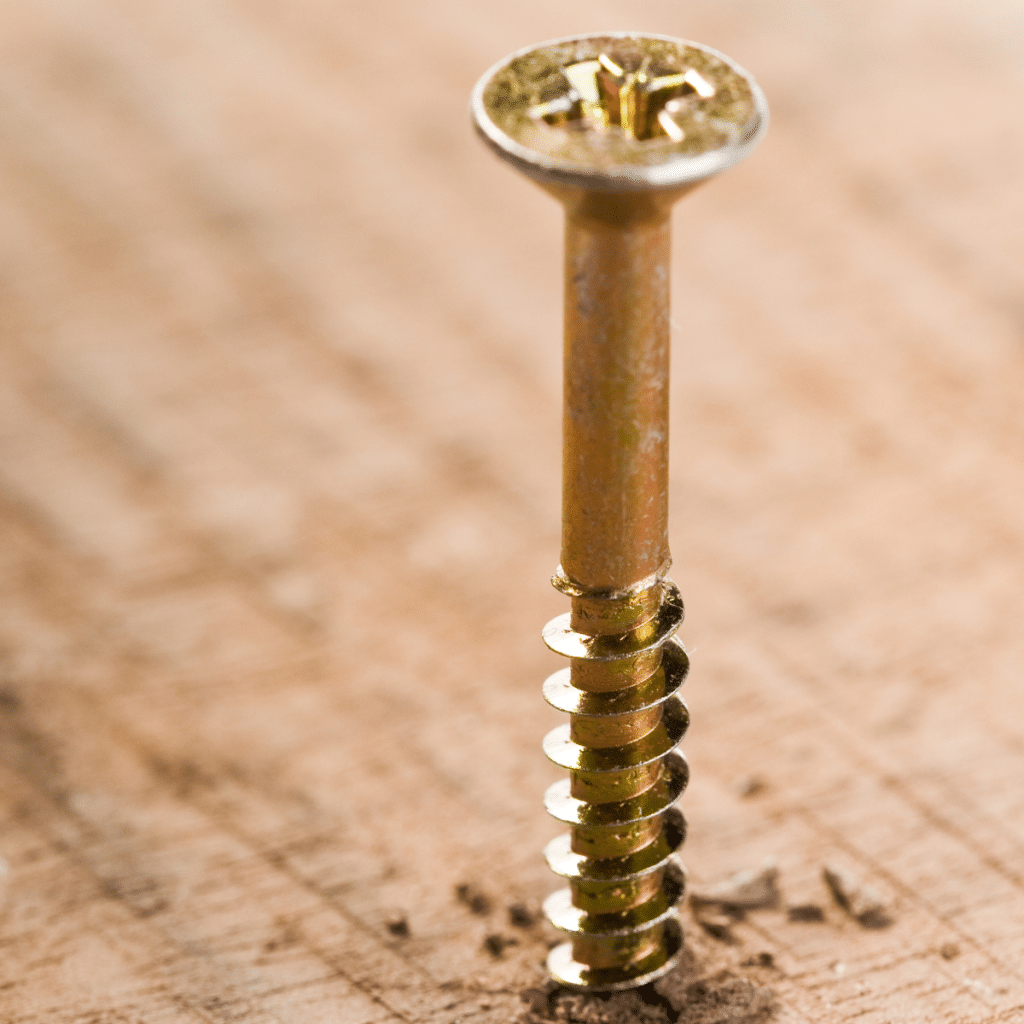 close up of log screw drilling through wood