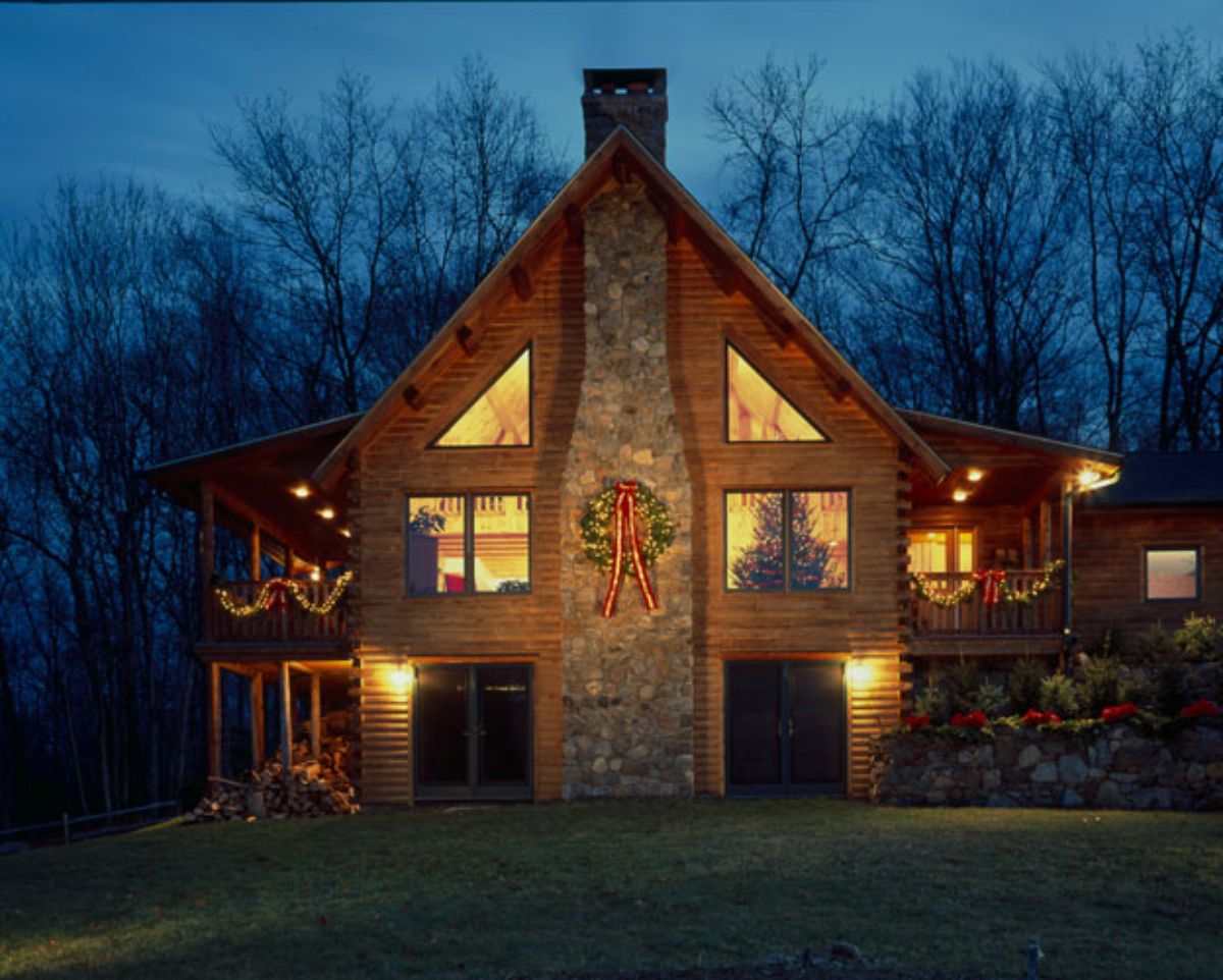 decorated huge log home against the night sky