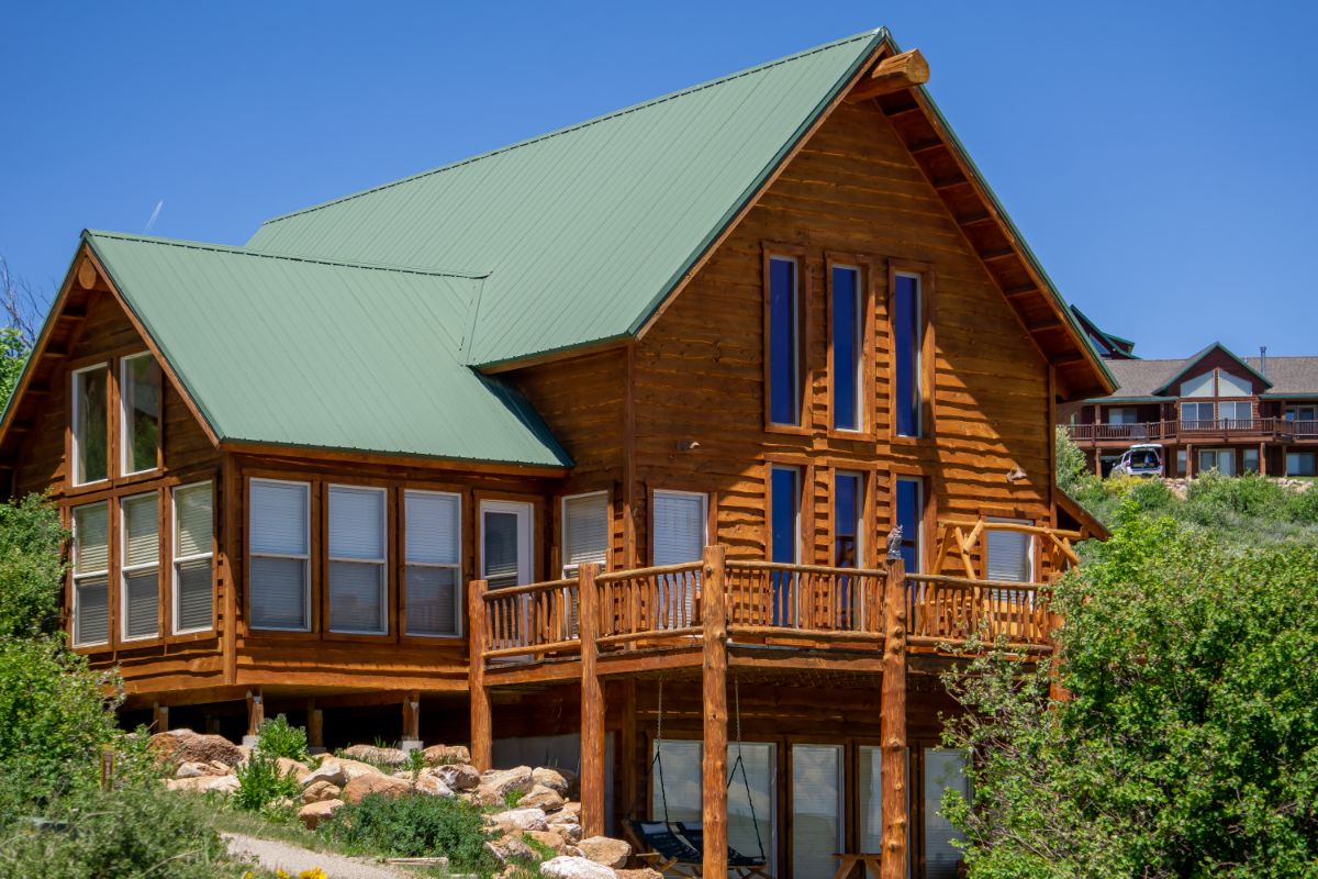 huge log home with green roof