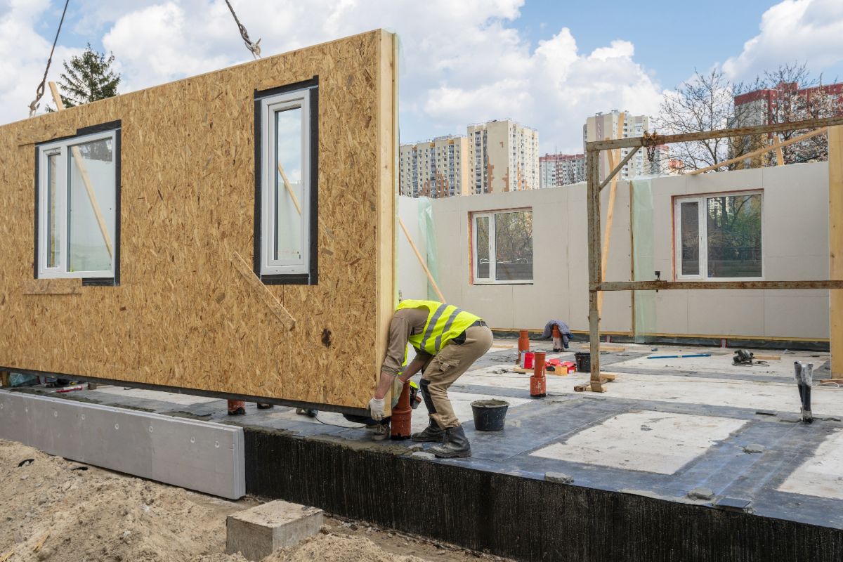 worker laying a structural insulated panel