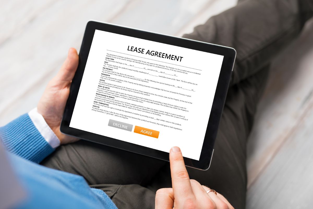 man holding a tablet with lease agreement