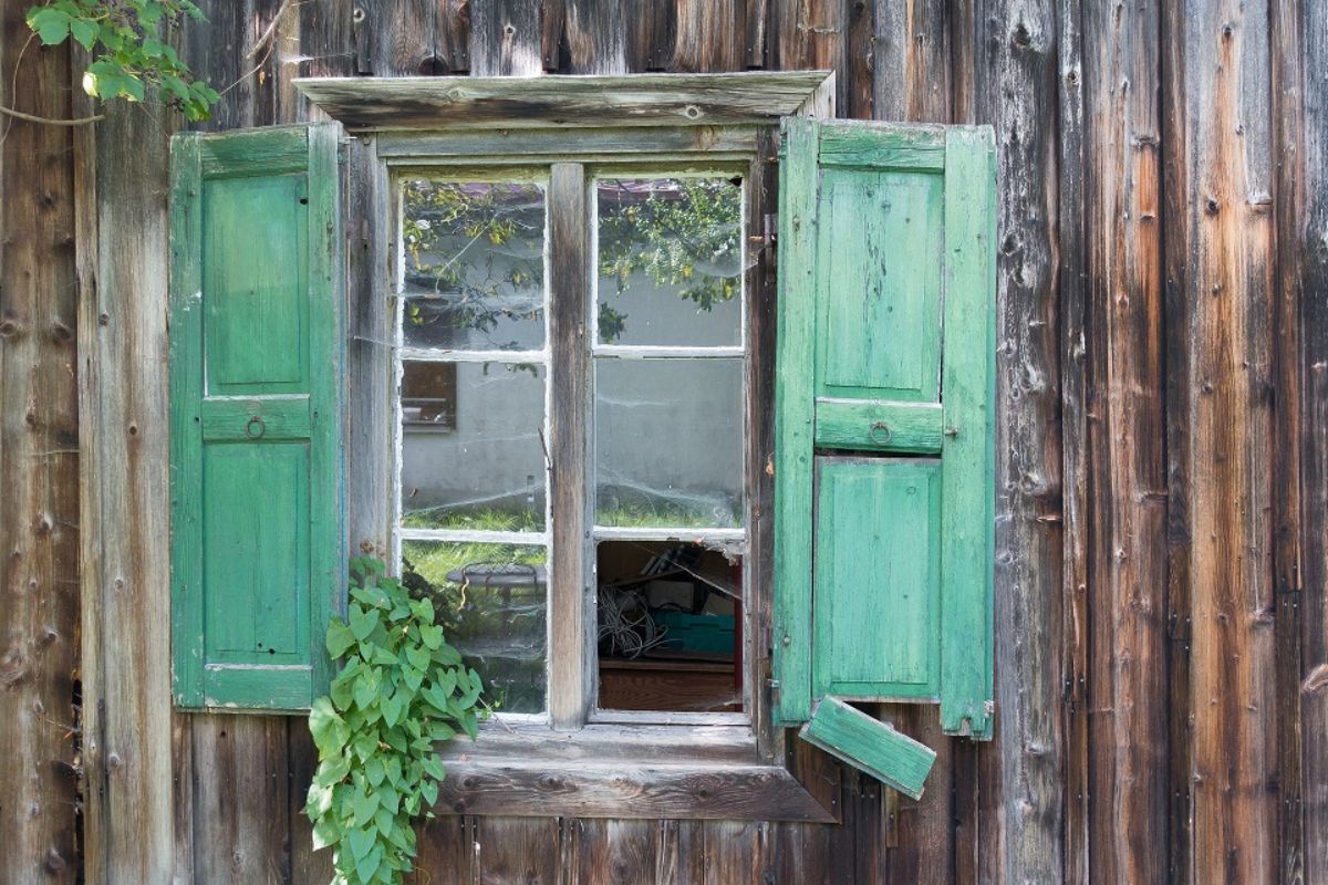 broken shutters of log cottage