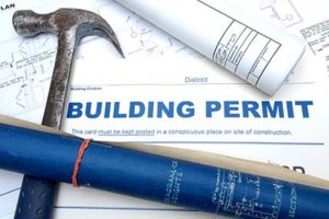 building permit paperwork with hammer