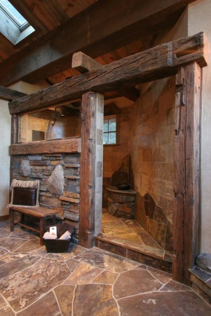 Rustic tone shower in a log cabin.