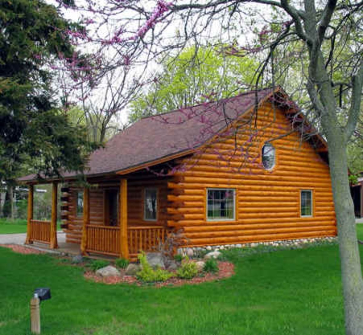 small log cabin surrounded by greenery