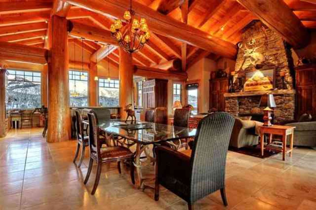 Log cabin dining room with fire mantel and dining table