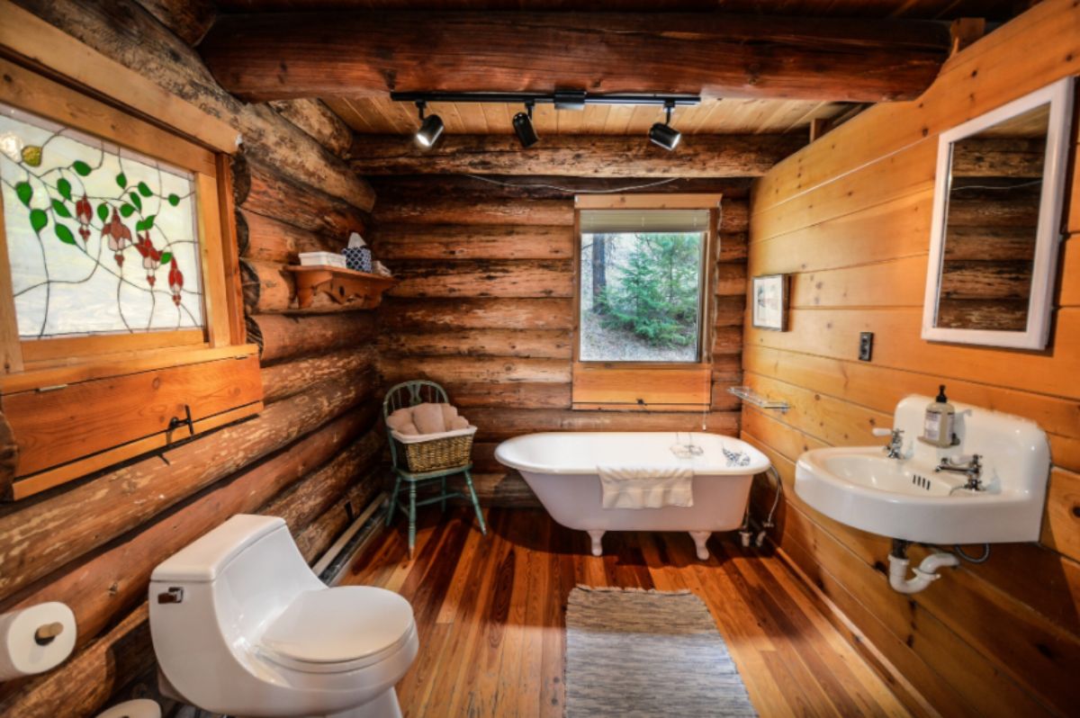 Log cabin bathroom with bathtub