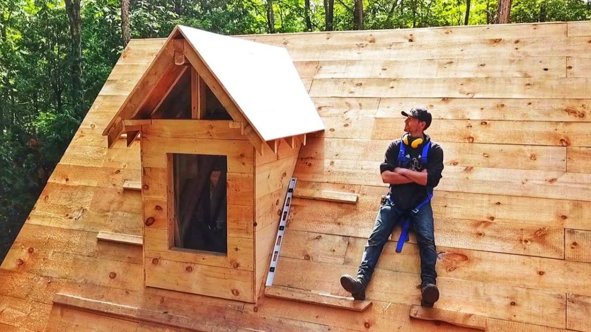 Contractor on log cabin roof