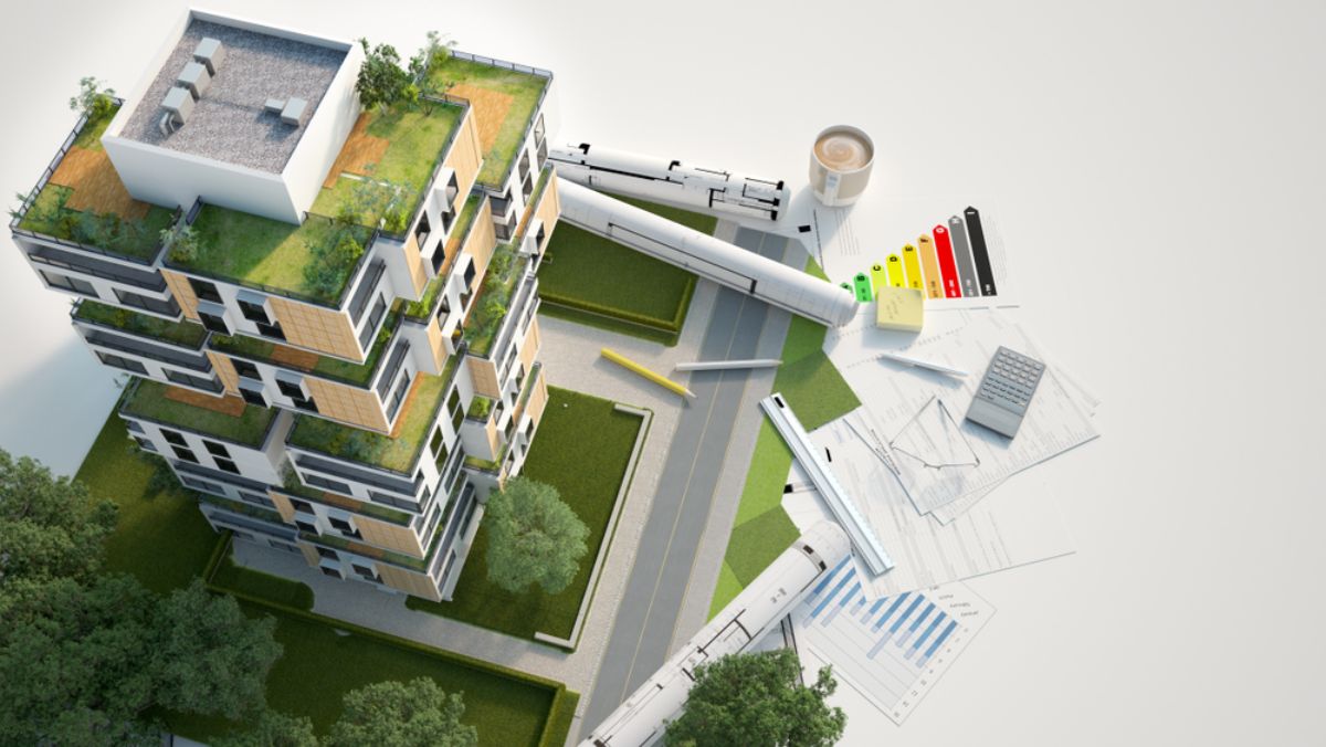 model of a green home building with blueprints