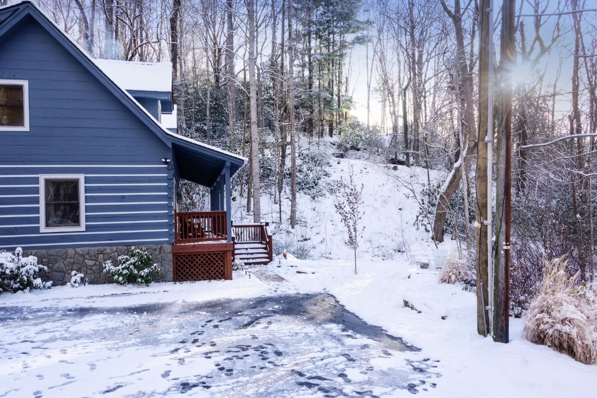 small log cabin surrounded by snow