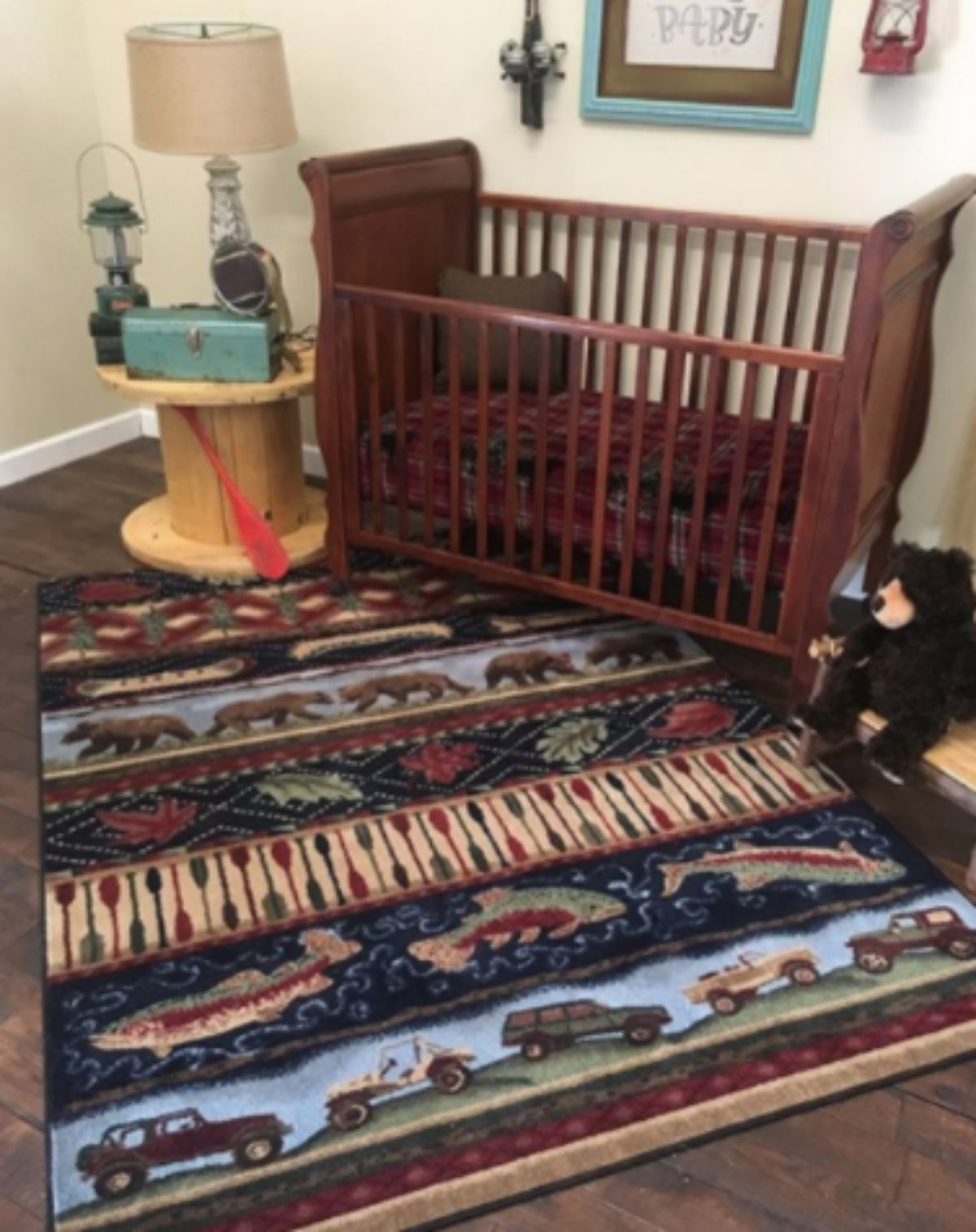 wildlife themed rug beside a baby's cot