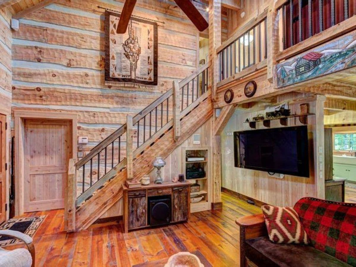 wood railing on stairs to second floor of log cabin