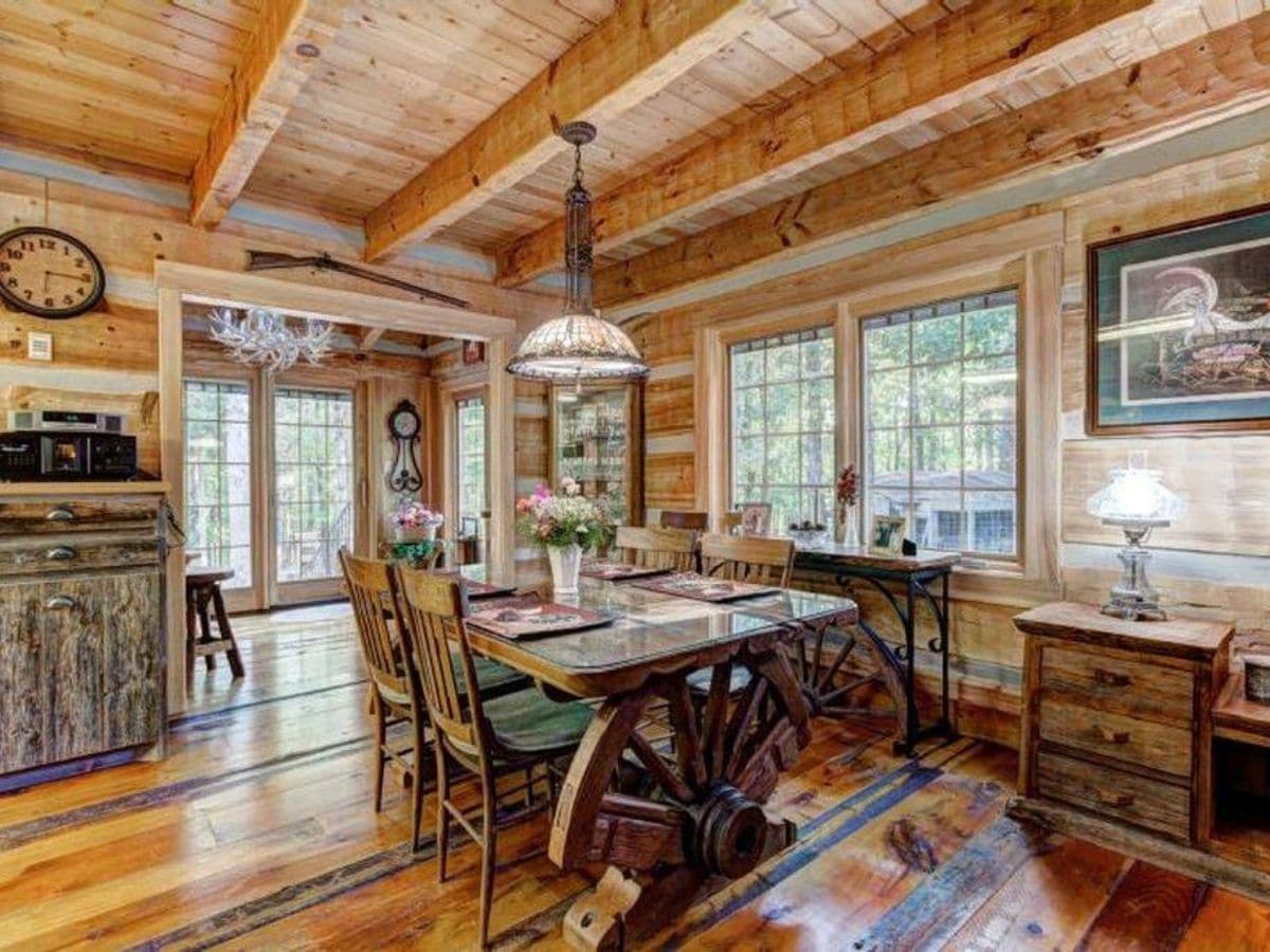 Timberlake log cabin with large dining room with french doors and wagon wheel table