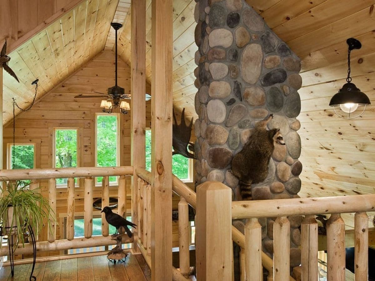 loft railing with stone fireplace in background