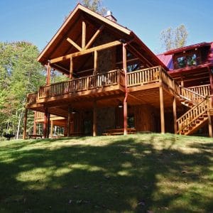 back of log cabin with decks