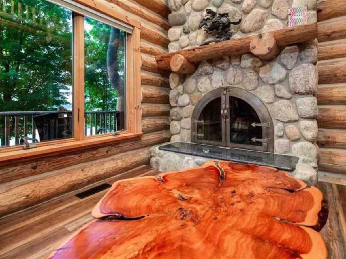 fireplace with wood coffee table in front