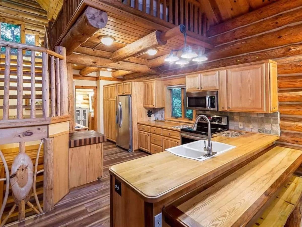 wood counters in log cabin kitchen with sink on front