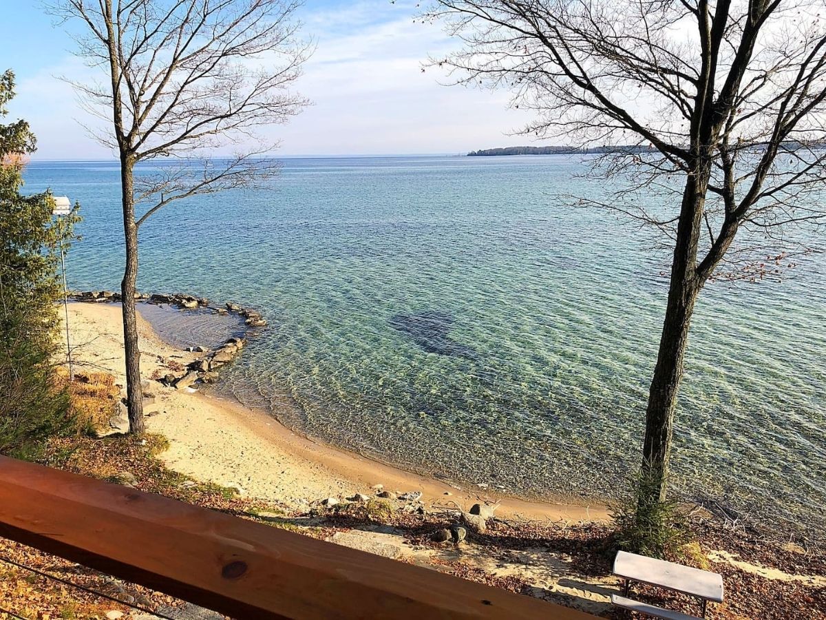 view of lake michigan and beach from balcony of cabin