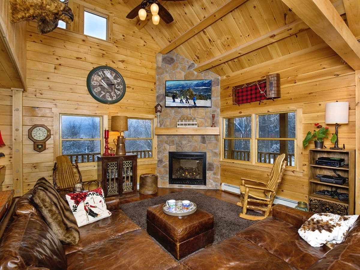 living room in log cabin with rocking chair near fireplace