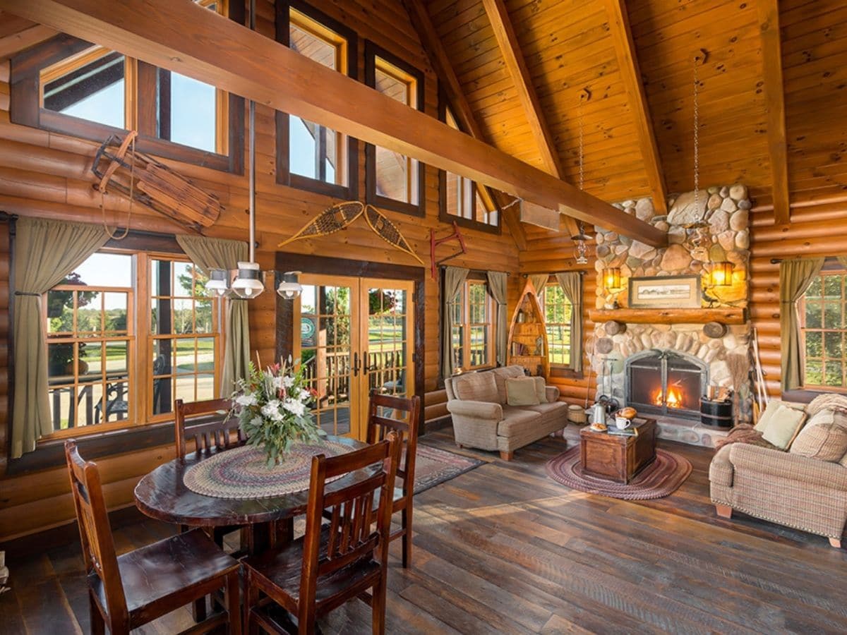 inside log cabin with tons of windows on front wall