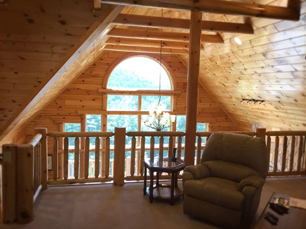 brown recliner in loft overlooking picture windows