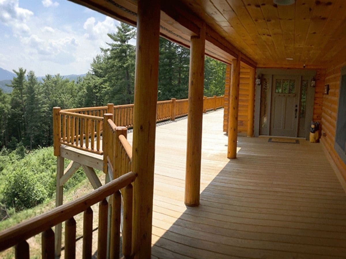 covered deck on side of log cabin