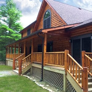 front porch on log cabin with lattice under porch