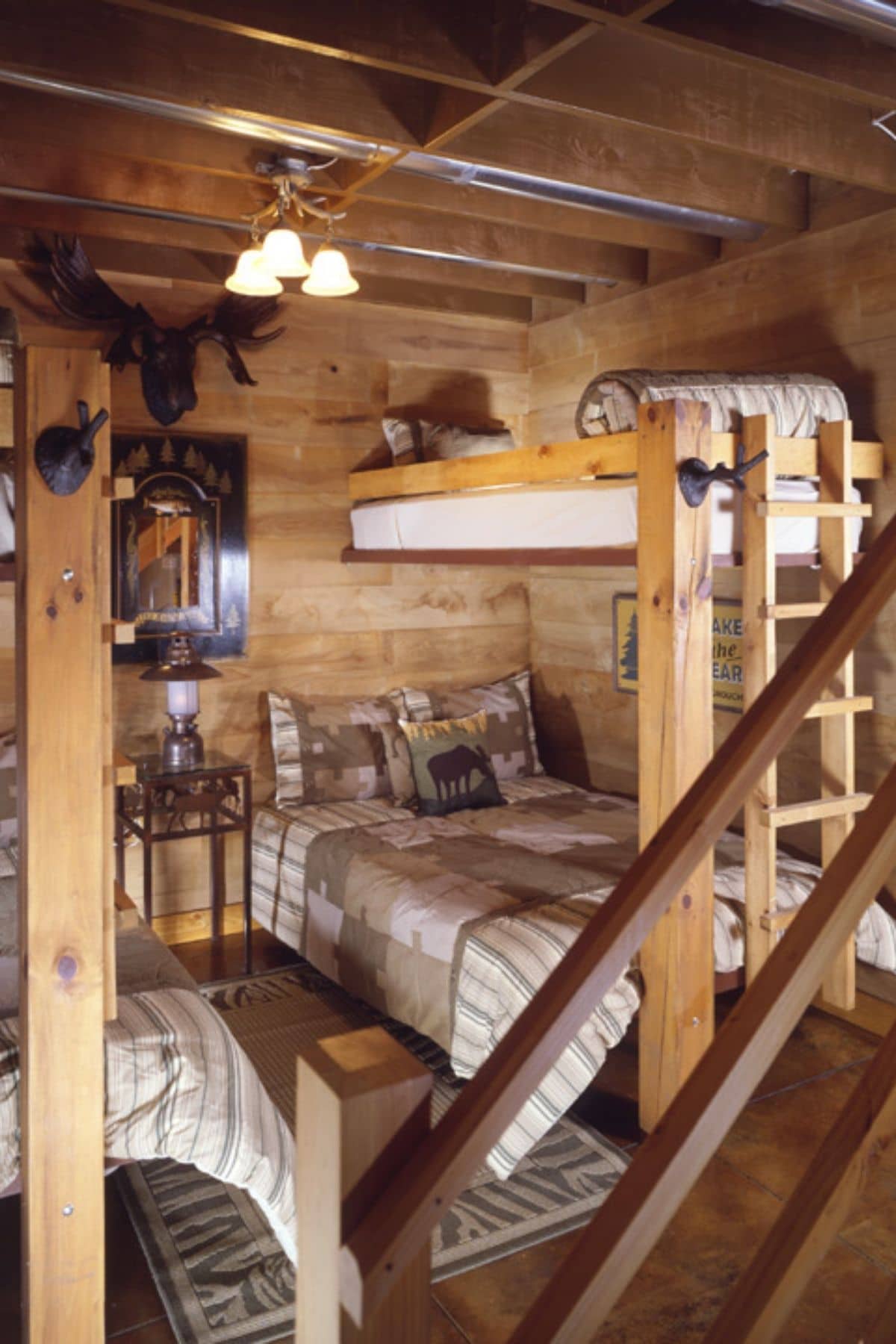 bunk beds near ladder in log room