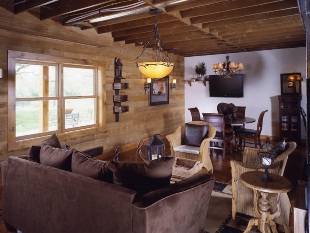 brown sofa in living room of log cabin