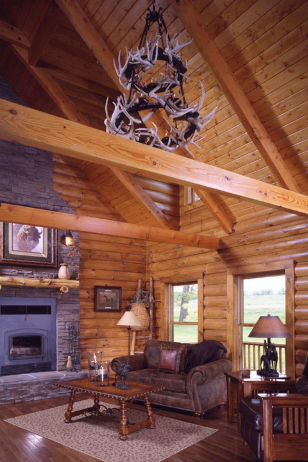antler chandelier above living room in log cabin