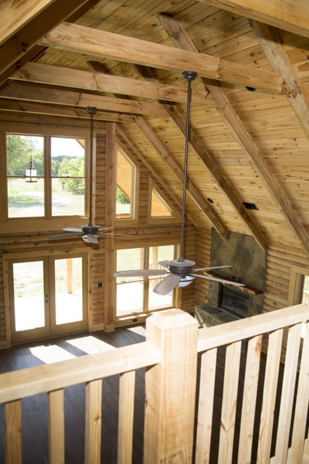 view down into log cabin living area from loft