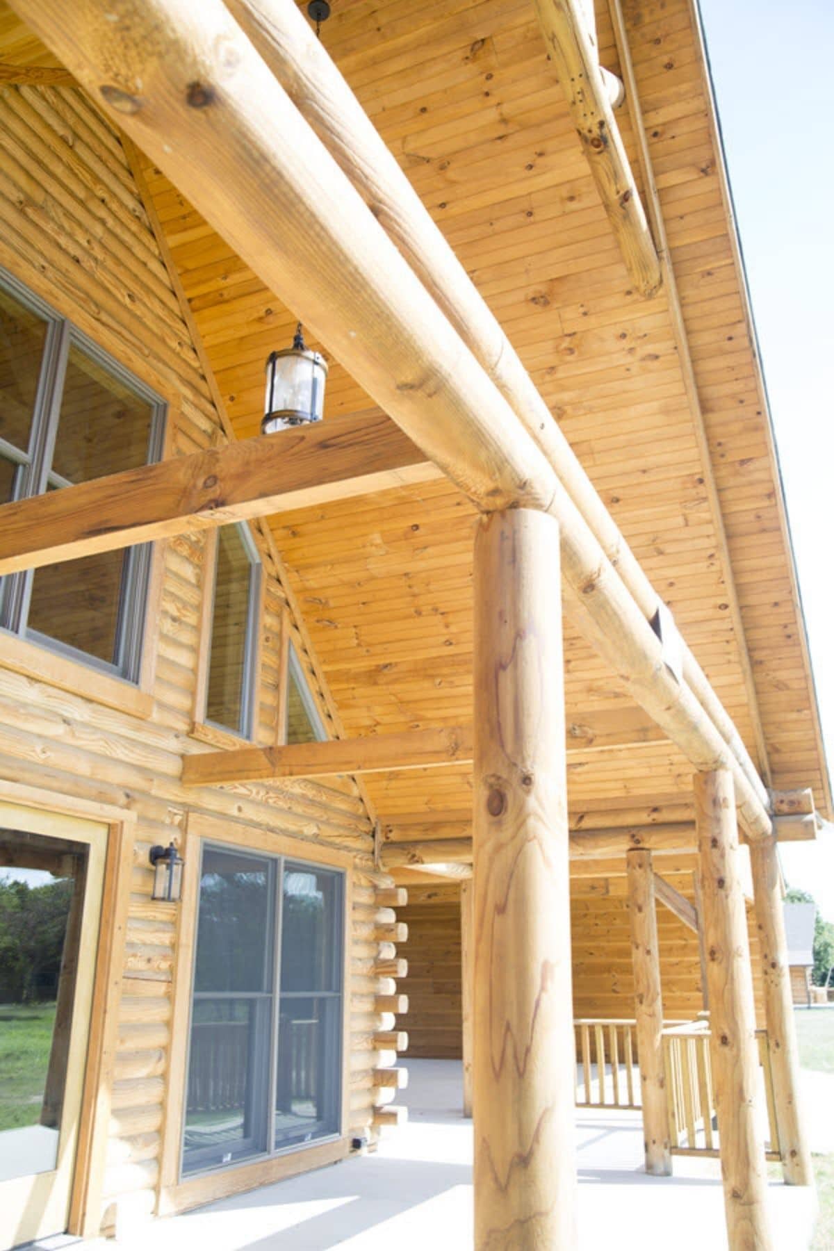 front porch on log cabin with log columns
