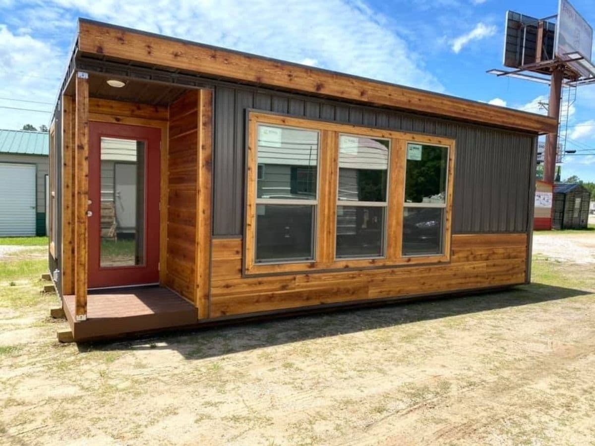 small cabin with cedar and dark gray vinyl exterior