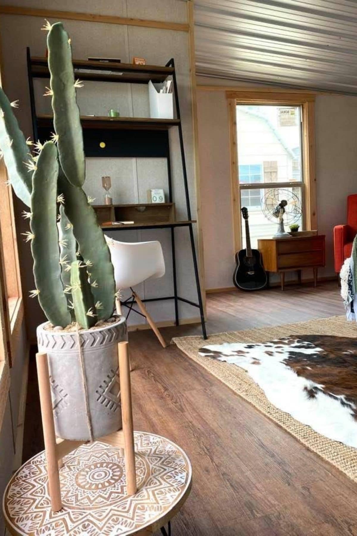 view toward front of tiny home showing window and desk