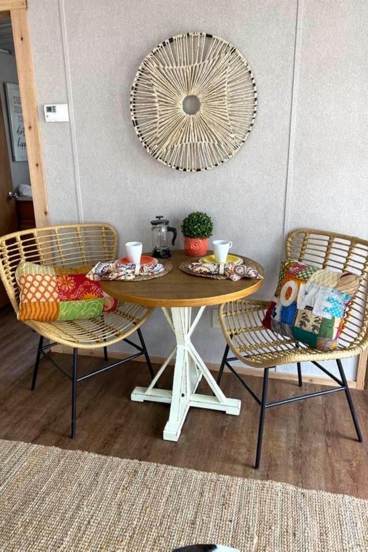 wicker chairs next to round table against wall