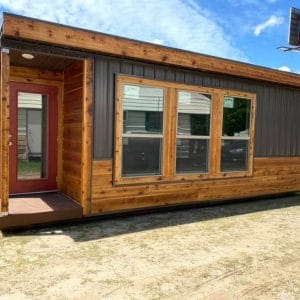 small cabin with cedar and dark gray vinyl exterior