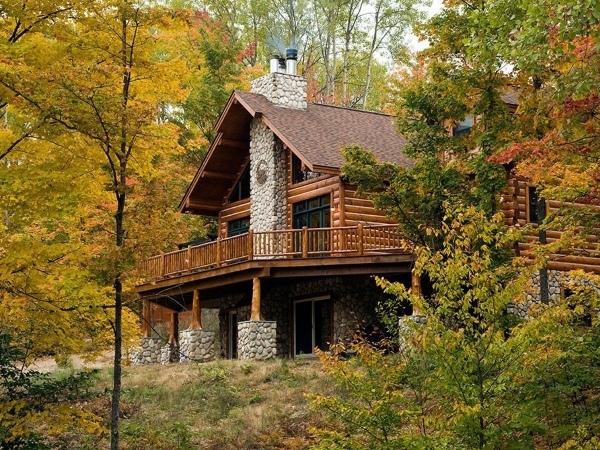 log cabin tucked into wooded area