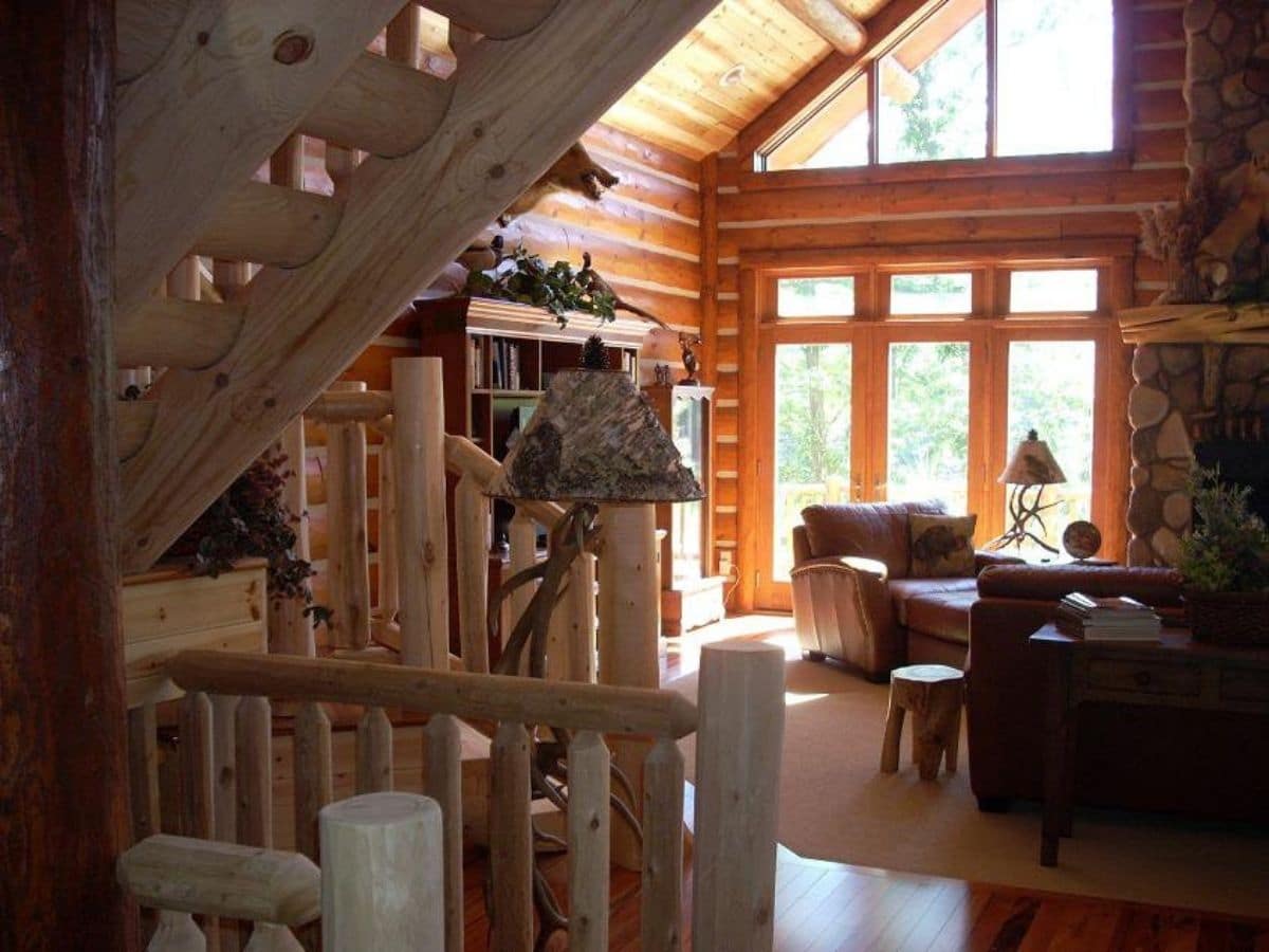 stairs to loft in foreground of log cabin