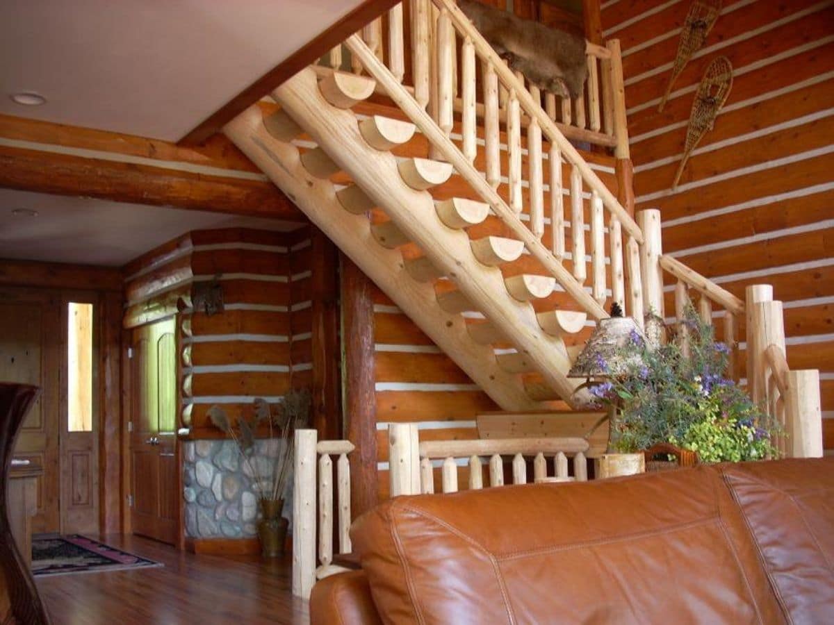 sofa in foreground with log stairs in background