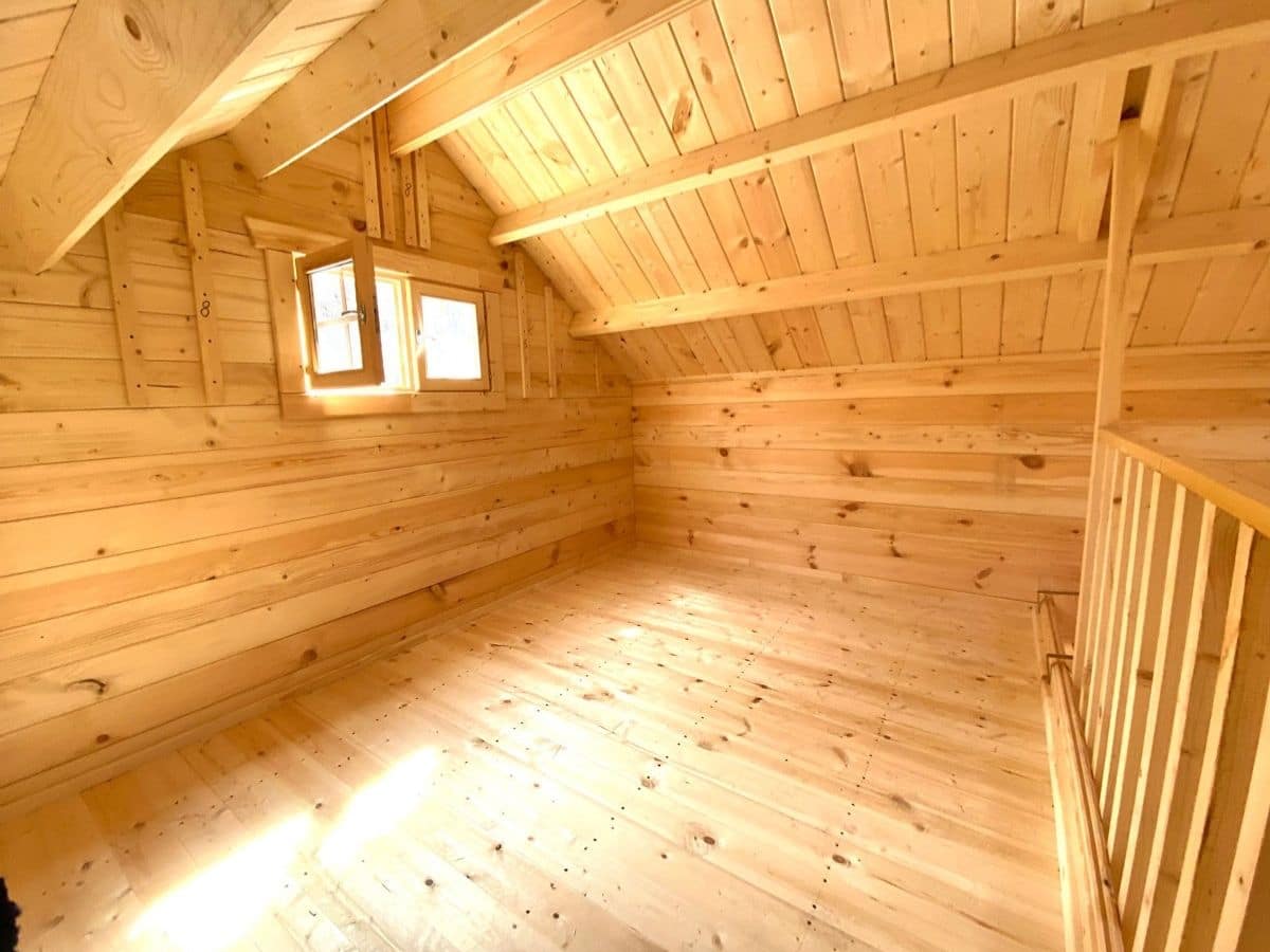 tiny log cabin with loft window open