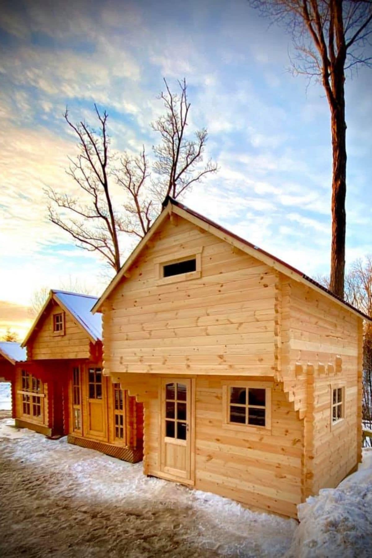 mini log cabins in a row in snow