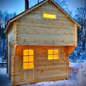 front of small cabin with loft window