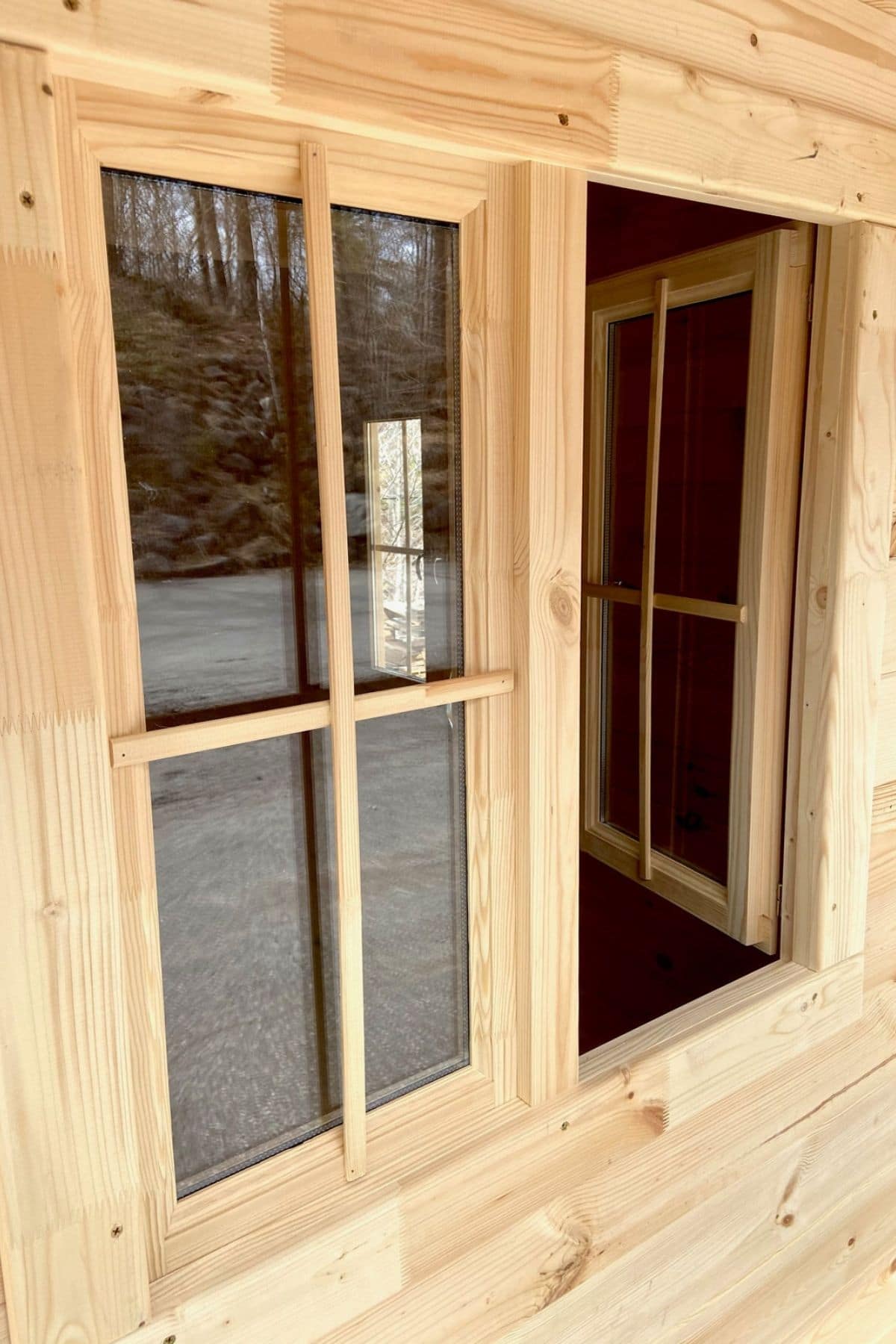 looking in at open window in log hut