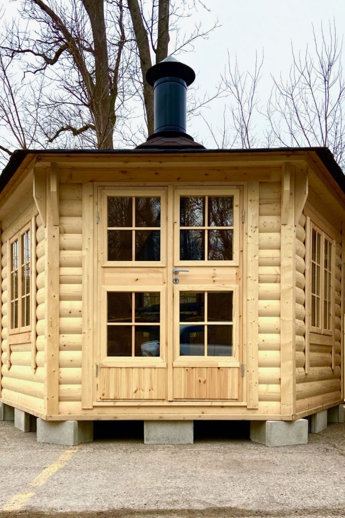 light wood log cabin with chimney