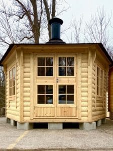 light wood log cabin with chimney
