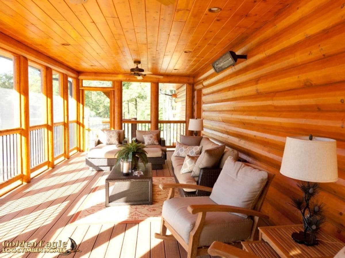 four seasons room with cozy chairs against log wall