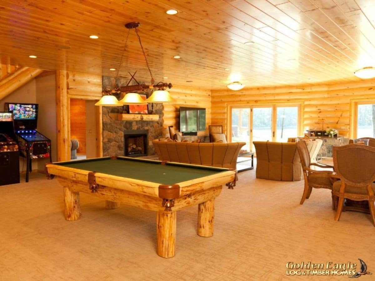 pool table in foreground of basement